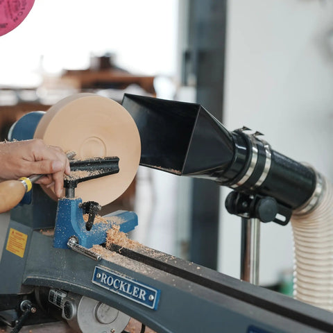 Premium Woodturning Dust Extraction Hood Featuring Flexible Rubber Cuff Universal Mount For Lathes And Turning Tools with wood chips.