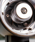 Close-up of 83mm red titanium flat burrs inside Killer Variable Speed Single Dose Coffee Grinder for smooth espresso pulls.