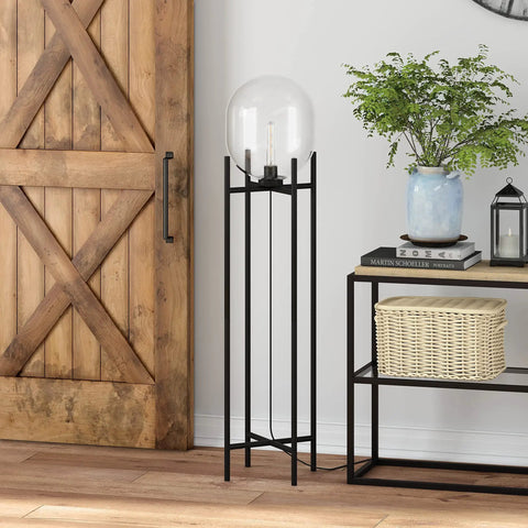 Tall Floor Lamp With Glass Shade In Blackened Bronze And Clear Finish, 55 Inch, placed next to a wooden cabinet and shelves