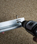 Beefy Shelf Bracket Kit 220 For 1.25 Inch By 58 And 9 Sixteenths Inch Shelves Includes 20 Brackets 4 Pilasters 40 Screws Pre Finished Maple Pilasters Easy Sliding Swing Lock Complete To Build Five Sturdy Shelves, metal bracket being drilled