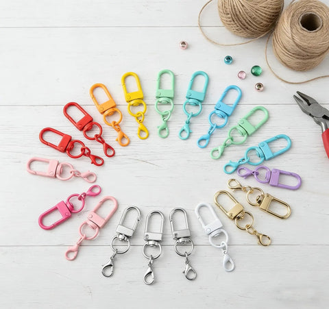 36 Pcs Colorful Swivel Snap Hooks Lobster Claw Clasps For Diy Crafts Jewelry Making Bag Charms in assorted colors on a wooden surface.
