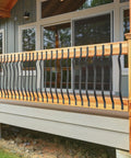 Straight Up Heavy Duty Cast Iron Curve Deck Balusters With Screws 29.5 Inch Wave Arc Metal Spindles Rust Resistant Black Railing Kit For Outdoor Steps Deck Porch displayed on a wooden railing.