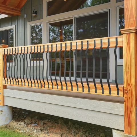 Straight Up Heavy Duty Cast Iron Curve Deck Balusters With Screws 29.5 Inch Wave Arc Metal Spindles Rust Resistant Black Railing Kit For Outdoor Steps Deck Porch displayed on a wooden railing.