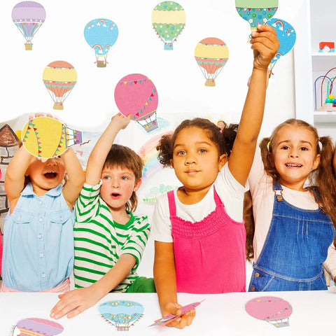 Children using Colorful Fun Hot Air Balloon Cutouts Set Of 45 5 By 7 Inch Classroom Bulletin Board Accents for activities.