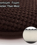 Close-up of brown U-shaped foam seat cushion showing thick high density foam layer and textured washable microfiber cover.
