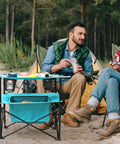 Lightweight Portable Camping Picnic Table With 4 Cup Holders And Carry Bag, Folding Beach Table in use at a campsite with two people