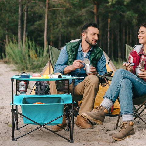 Lightweight Portable Camping Picnic Table With 4 Cup Holders And Carry Bag, Folding Beach Table in use at a campsite with two people