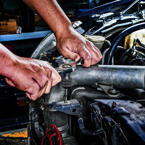 Reversible Ratcheting T Handle Tap Wrench Smooth Reverse Action Makes Stubborn Threads Go Like Butter With Zero Hassle And Real Muscle For Auto Technicians being used on an engine.