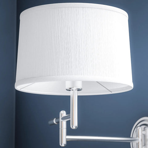 Theta Wall Swing Arm Lamp in brushed steel finish with adjustable arm, close-up of white drum shade against blue wall