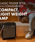 Frontman 10G 10 Watt Electric Guitar Amplifier With 6 Inch Speaker Built In Overdrive Headphone Jack And Aux Input Black Silver Classic Sixties Vibe For Practice And Small Gigs Two Year Warranty next to person playing guitar