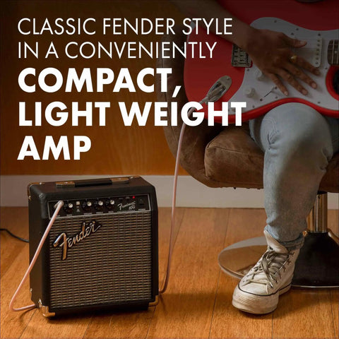 Frontman 10G 10 Watt Electric Guitar Amplifier With 6 Inch Speaker Built In Overdrive Headphone Jack And Aux Input Black Silver Classic Sixties Vibe For Practice And Small Gigs Two Year Warranty next to person playing guitar