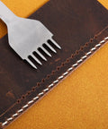 Leather Stitching Punch Kit With White Steel Prongs 5mm Pitch 6 prong tool on stitched leather piece