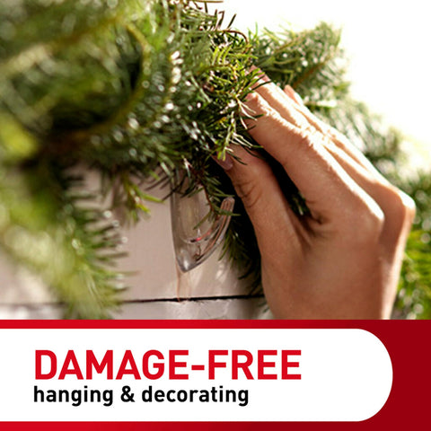 Hand using Clear Medium Wall Hooks Set with 7 Hooks and 12 Adhesive Strips for damage-free hanging on decorated wall