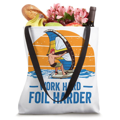 Work Hard Foil Harder Wing Foil Wingsurfing Tote Bag with handles, packed with groceries, featuring wing surf graphic.