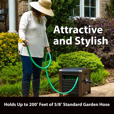 Person using Beefy 200 Foot Hose Storage Box With Internal Poly-Resin Reel, bronze finish, in garden with green hose