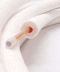 1/4-inch insulated copper coil line with white foam insulation; close-up view.