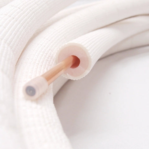 1/4-inch insulated copper coil line with white foam insulation; close-up view.