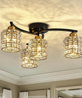 Four Light Crystal Flush Mount Ceiling Light in black and gold with crystal shades, installed in a living room, modern farmhouse style.