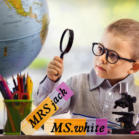Child examining globe with Eight Pieces Personalized Pencil Name Plate Set With Blank Wooden Desk Signs in classroom