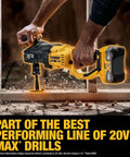Hands holding the Badass Heavy Duty Cordless Stud And Joist Drill Kit Includes 20V Max Battery And Charger with wood shavings flying.