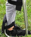 Person wearing strap-on Set Of 2 Knee Seats For Gardening, Strap On Kneeling Pads For One Leg Support, in grass, close-up view.
