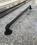 Built Rock Solid Black Wrought Iron Stair Handrail, Heavy Duty Galvanized Pipe Step Railing mounted on a granite surface.
