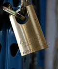 Rekeyable Padlock With Zero Bitted Uncut Keys For Locksmith Cut High Security Steel Padlock With Shrouded Shackle And Dual Ball Bearing Locking Great For Lock Up Your Home Garage Gate And Storage Security Upgrades secured to a blue metal beam.