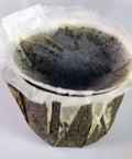 Close-up of unbleached paper filter with lid for Keurig K Cup single serve brewers fits Ekobrew EZ Cup and other reusable coffee filters