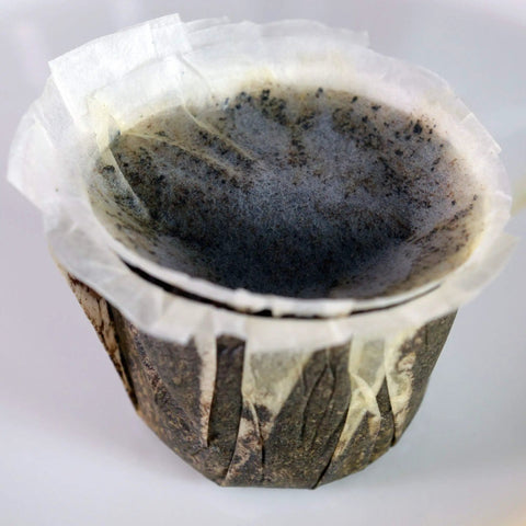 Close-up of unbleached paper filter with lid for Keurig K Cup single serve brewers fits Ekobrew EZ Cup and other reusable coffee filters