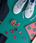 Super Hold Tape With 50 Percent More Adhesive, Clear Finish, 2 Rolls, Dispenser Ready, surrounded by games, shoes, and clothes on table