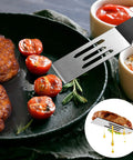 Two-piece stainless steel slotted spatula set for kitchen use, ideal for turning and serving small portions.