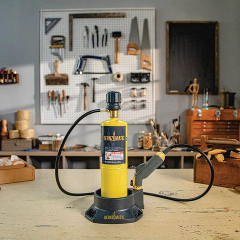 Pro Grade Precision Flame Hand Torch With Adjustable Heat For MAP Pro Propane Fuel on a workshop table with tools.