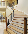 Indoor staircase with black iron baluster shoes for half-inch square balusters on curved railings, rust-resistant black finish