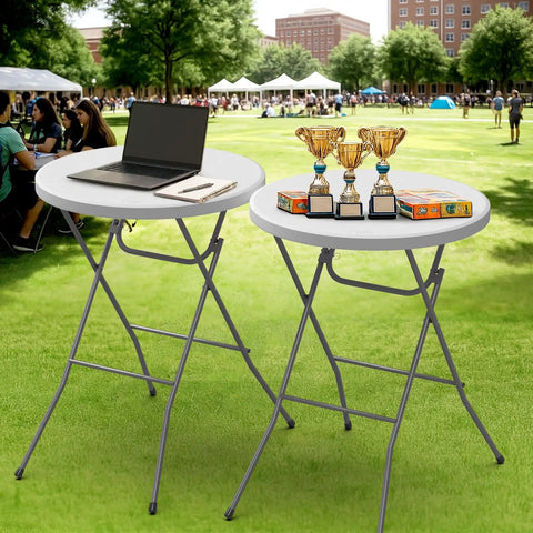 32 Inch Plastic Folding Round Bar Height Table With Gray Metal Finish For Outdoor Parties Cafes Restaurants Backyard Weddings Durable HDPE Construction 350 Lb Capacity Easy Setup White. Tables with laptop and trophies on lawn.