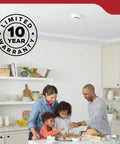 Family cooking in a modern kitchen with Rock Solid Hardwired Smoke Detectors With AA Battery Backup And Interconnectable Wiring.