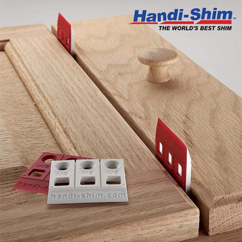 Heavy Duty Reusable Plastic Construction Shims For Spacing And Leveling, 40 Piece Assorted Pack In Four Sizes One Thirty Second Inch One Sixteenth Inch One Eighth Inch One Quarter Inch Ideal For Deep Applications Handi Shim on wooden surface showcasing various shim sizes.