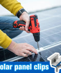 Person installing adjustable solar panel mounting bracket clamps kit for aluminum roof mount with drill, close-up view.