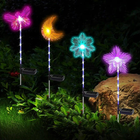 Solar Garden Stake Lights 4 Pack With RGB Color Changing LEDs displayed in garden setting, showing vibrant color modes and solar panels