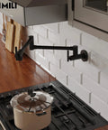 Slick Matte Black Pot Filler Faucet With A 24 Inch Swivel Arm and Smooth Dual Handles over a stove with a pot.