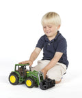 Child playing with John Deere 6920 Front Loader Tractor 1 16 Scale Toy For Indoor And Outdoor Play Built Tough From ABS Plastic