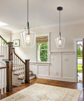 Modern Black And Gold Glass Pendant Light 2 Pack With Adjustable Height Cord For Kitchen Island Clear Round Shade E26 Socket hanging in a stylish entryway.