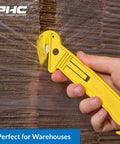 Heavy Duty Dual Head Concealed Safety Cutter Hits Different For Slicing Shrink Wrap Film Cardboard And Plastic Straps With Recessed Blades For Zero Slip Protection And No Sweat All Day Long, cutting through plastic wrap.