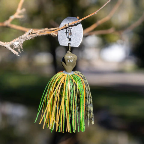 Weedless Bass Jig With Bladed Vibration Tech For Pike Walleye Muskie Six Color Lures Set hanging on branch outdoors.