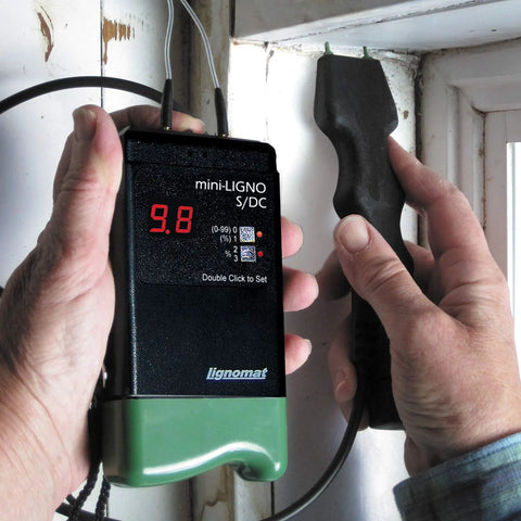 Person using S4-P And Mini-Ligno SD/C Moisture Meter And Mold Detector Kit With E14-M Electrode on window frame