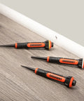 Three-piece set of 5 Inch Gripped Punch Set With Full Metal Core And Comfort Grip on a wooden surface.