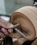 Top Notch M2 High Speed Steel Cryogenically Treated Bowl Gouge For Woodturning in use, shaping a clay bowl on a lathe.