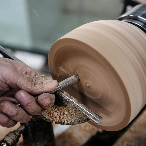 Top Notch M2 High Speed Steel Cryogenically Treated Bowl Gouge For Woodturning in use, shaping a clay bowl on a lathe.