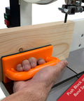 Hand using push block on band saw from 4 Piece Woodworking Safety Kit With Magnetic Push Stick, Straight And Angled Push Blocks, And Table Saw Feather Board For Router Tables, Jointers And Band Saws, Boost Safety And Reduce Kickback For A Safer Smoother Shop Experience.