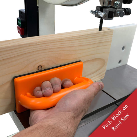 Hand using push block on band saw from 4 Piece Woodworking Safety Kit With Magnetic Push Stick, Straight And Angled Push Blocks, And Table Saw Feather Board For Router Tables, Jointers And Band Saws, Boost Safety And Reduce Kickback For A Safer Smoother Shop Experience.