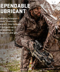Hunter using a crossbow with Premium Crossbow Lubricant With Foam Applicator in a snowy woodland setting.